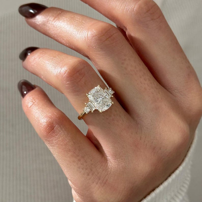 Elongated cushion moissanite cluster engagement ring with baguette and round side stones in yellow gold, view 2