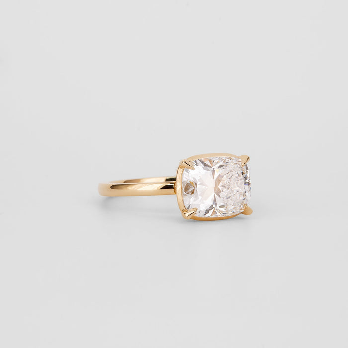 East west elongated cushion moissanite solitaire engagement ring in yellow gold