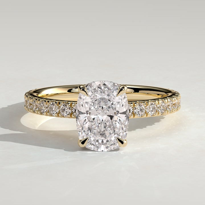 Elongated cushion moissanite engagement ring on a full pave eternity band in yellow gold