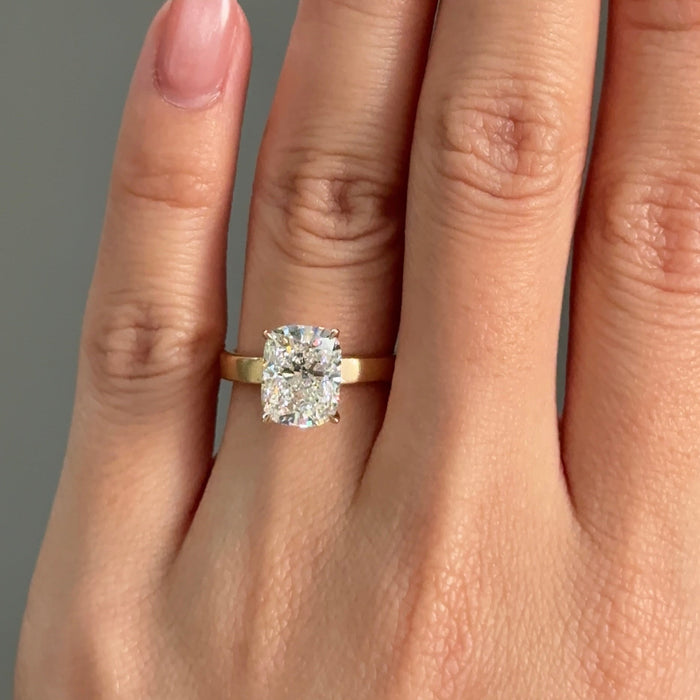 Elongated cushion moissanite flat band solitaire engagement ring in yellow gold, view 2