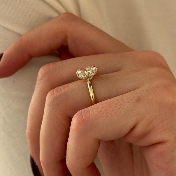 Elongated cushion moissanite hidden halo engagement ring in yellow gold, view 2