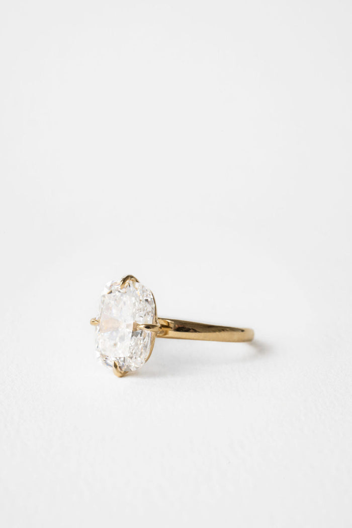Large elongated cushion moissanite solitaire engagement ring on a hammered yellow gold band, view 2