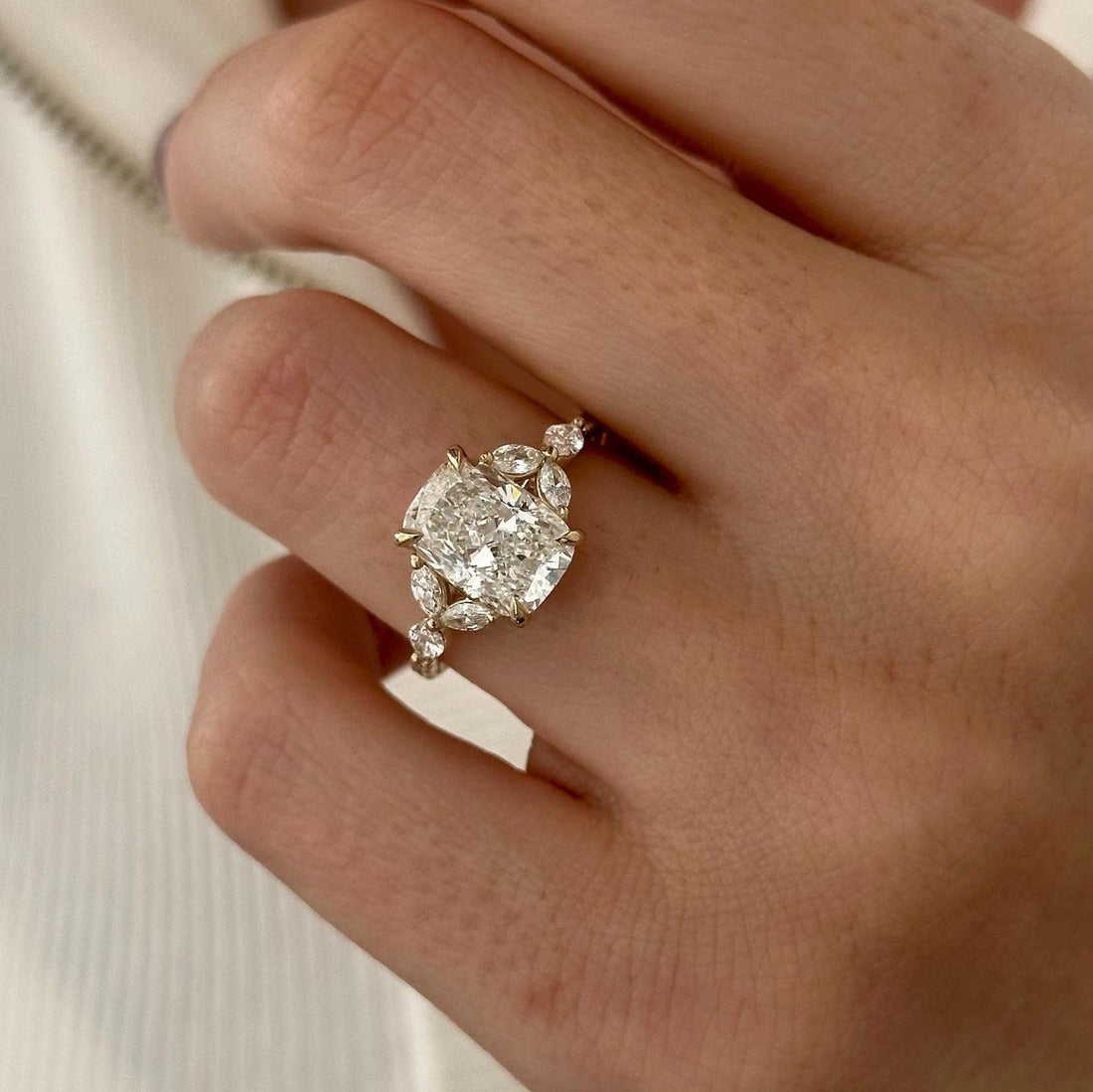 Elongated cushion moissanite marquise leaf cluster engagement ring in yellow gold