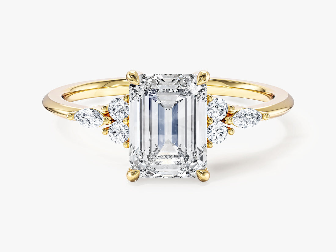 Vintage emerald cut moissanite engagement ring with marquise cluster sides in 14K yellow gold, front view