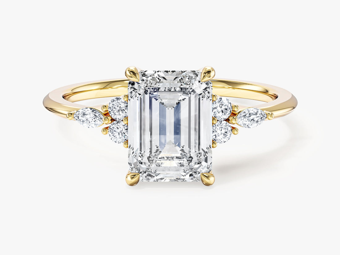 Emerald cut moissanite four claw engagement ring with marquise accent clusters in 14K yellow gold, front view