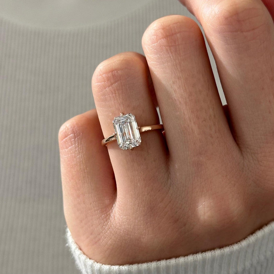 Emerald cut moissanite solitaire engagement ring in rose gold