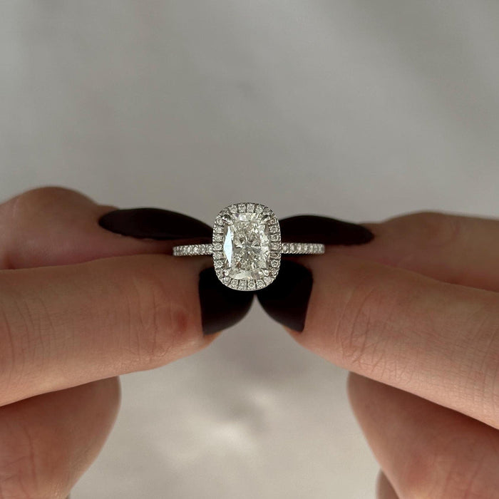 Elongated cushion moissanite halo engagement ring with pave band in white gold