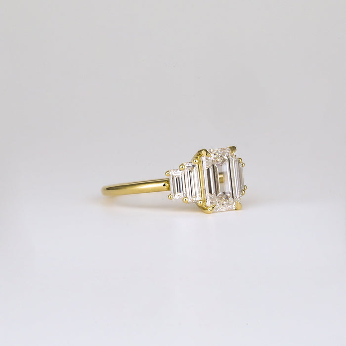 Emerald cut moissanite five stone engagement ring with graduated baguettes in yellow gold, view 2