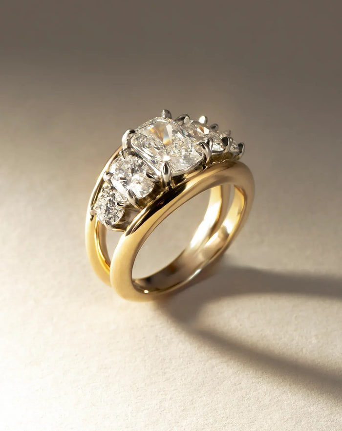 Elongated cushion moissanite five stone two tone rail engagement ring in yellow gold, view 2