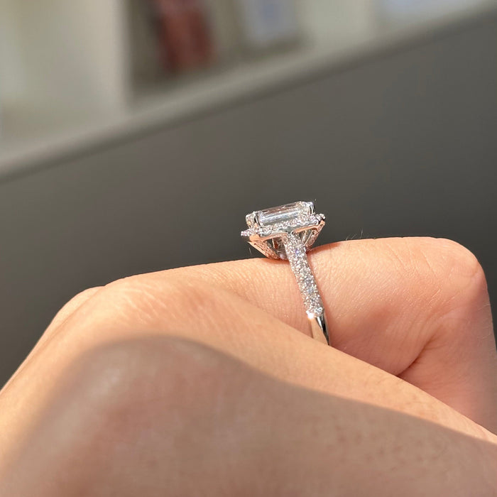 Emerald cut moissanite halo engagement ring on a three row pave white gold band, view 2
