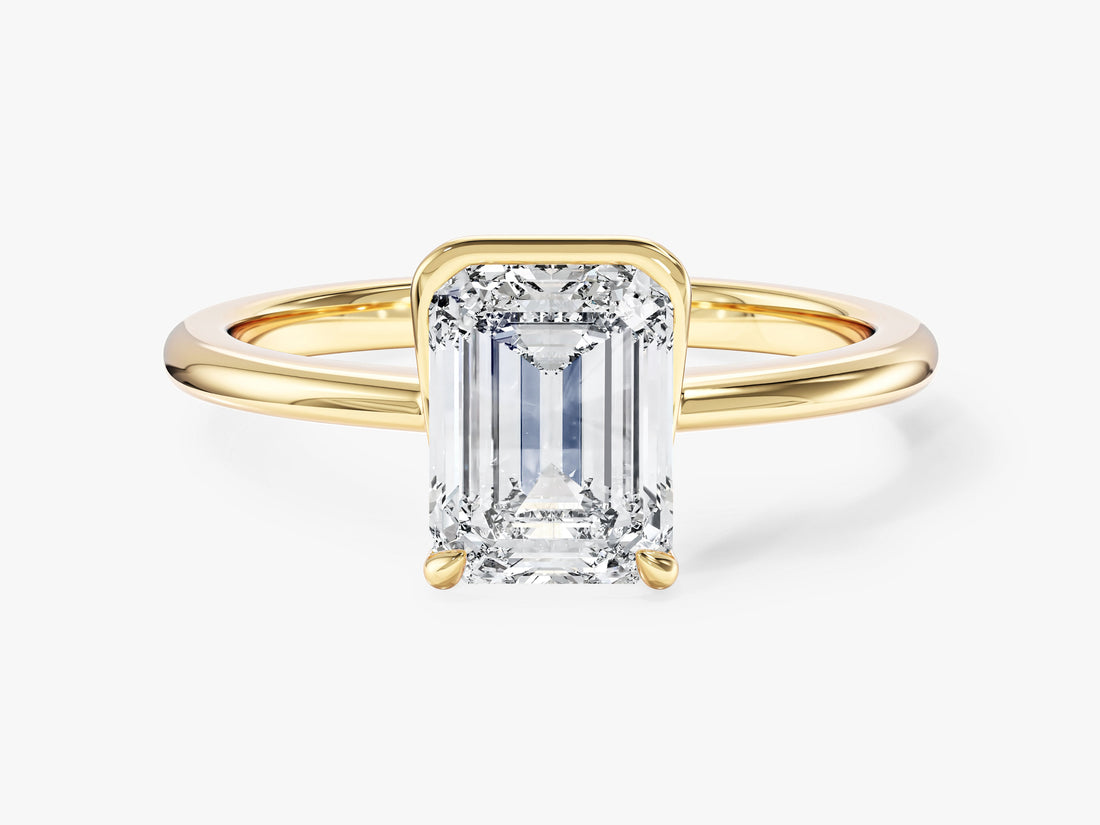 Emerald cut moissanite half bezel solitaire engagement ring in 14K yellow gold, front view