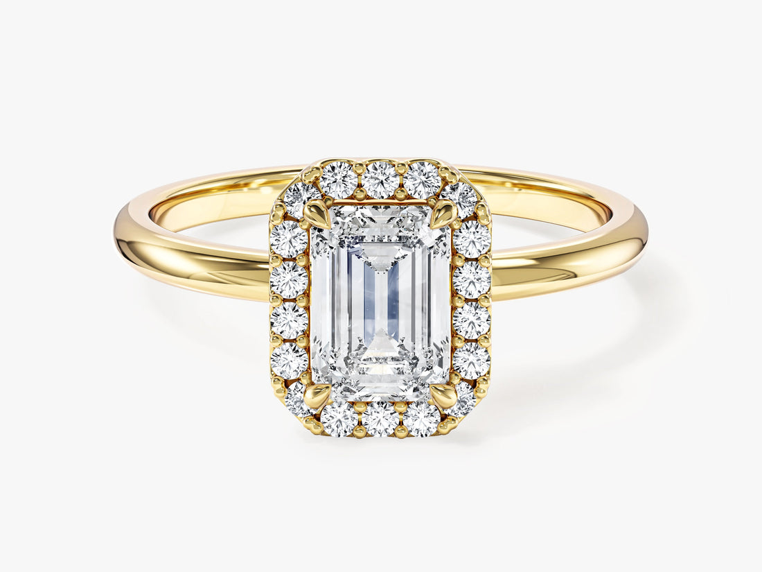 Dainty emerald moissanite halo engagement ring with slim polished shank in yellow gold