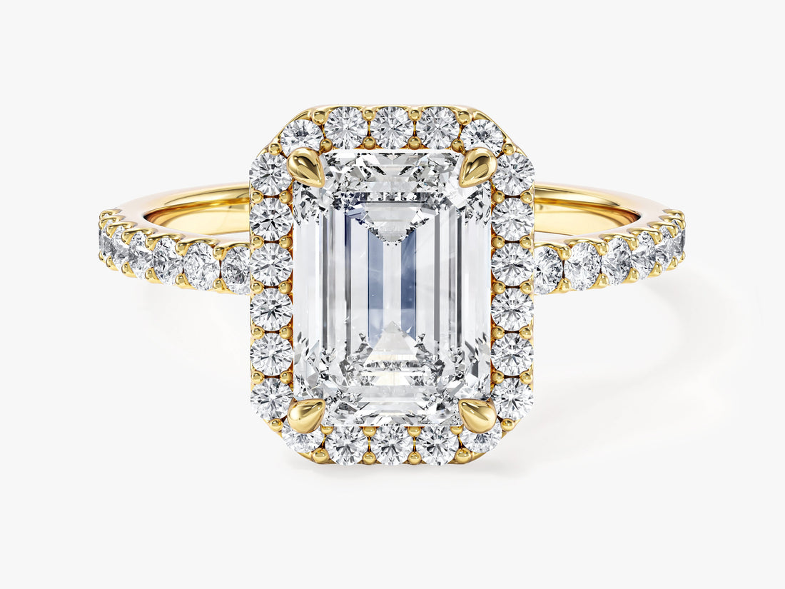 Emerald cut moissanite halo engagement ring with pave band in 14K yellow gold, front view