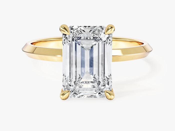 High set emerald cut lab grown diamond solitaire with knife edge band in yellow gold, front view