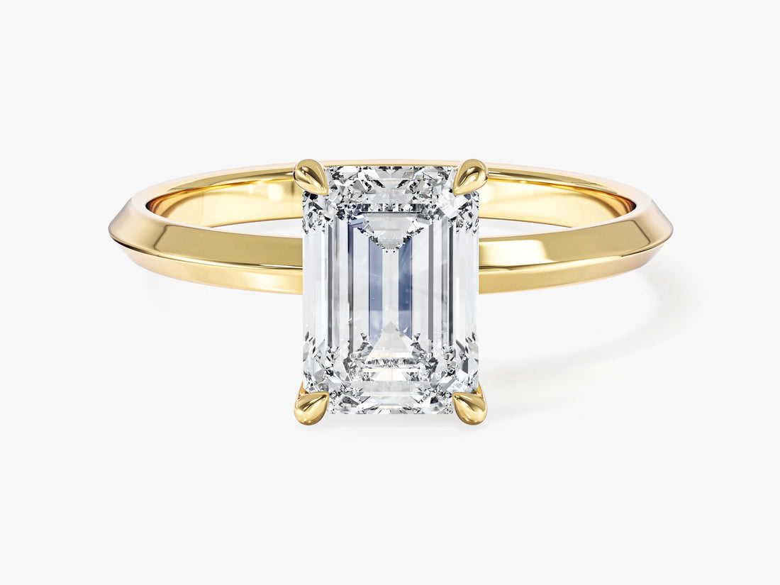Emerald cut moissanite knife edge solitaire engagement ring in 14K yellow gold, front view