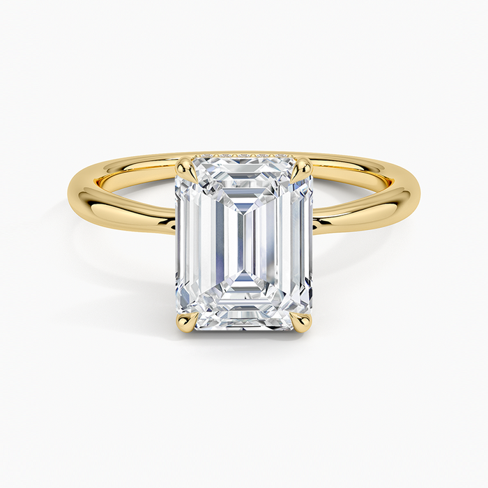 Emerald cut moissanite hidden halo solitaire engagement ring in yellow gold, top view