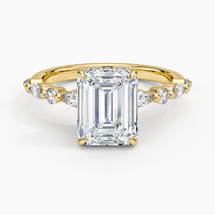 Emerald cut moissanite hidden halo ring with alternating marquise and round band in yellow gold, top view