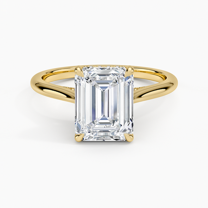 Emerald cut moissanite hidden halo cathedral split shank engagement ring in yellow gold, top view