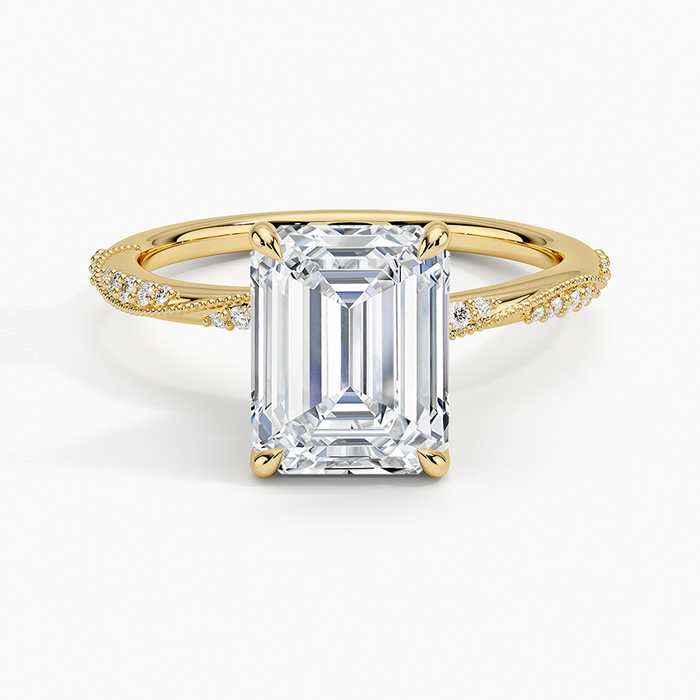 Emerald cut moissanite twisted pave and milgrain engagement ring in yellow gold, top view