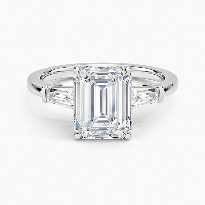 Emerald cut moissanite three stone ring with tapered baguette sides in white gold, top view