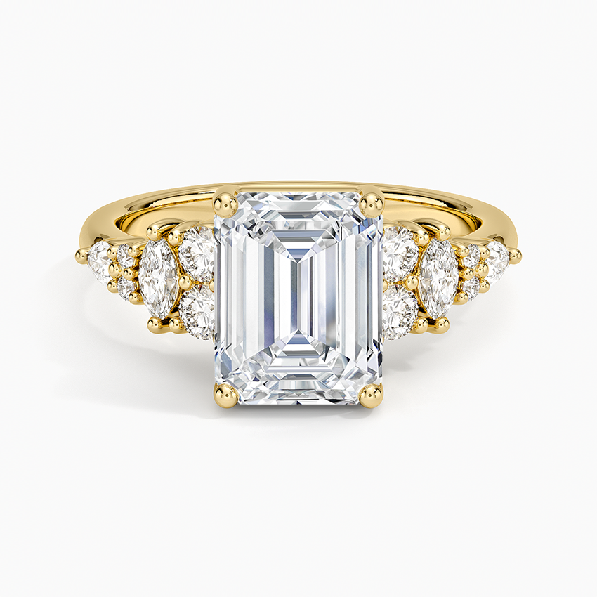 Emerald cut moissanite ring with marquise and round cluster shoulders in yellow gold, top view