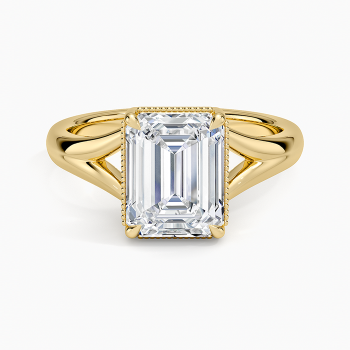 Emerald cut moissanite split shank milgrain solitaire ring in yellow gold, top view