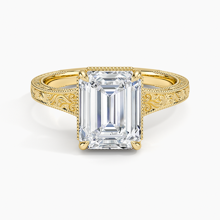 Hand engraved scroll cathedral emerald cut moissanite ring in yellow gold, top view