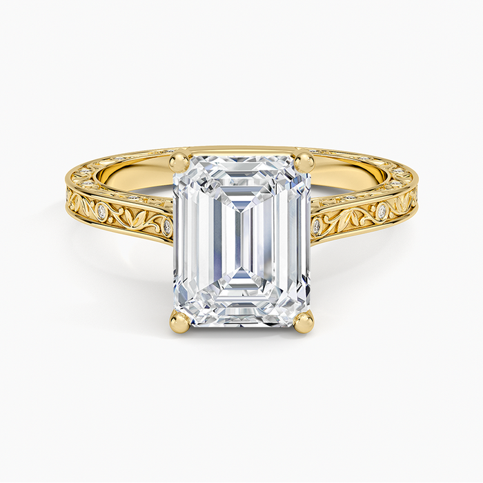 Emerald cut moissanite engraved vine ring with flush set accents in yellow gold, top view
