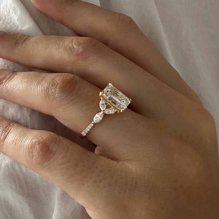 Emerald cut moissanite marquise cluster halo engagement ring in yellow gold, view 2