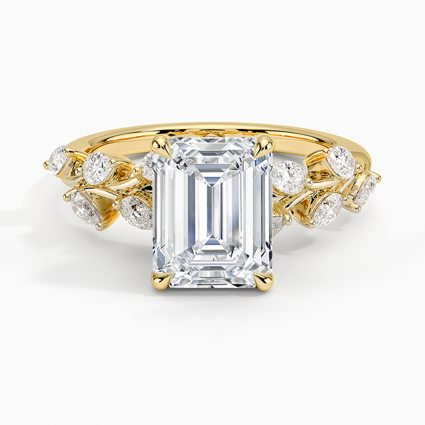 Emerald cut moissanite with scattered botanical marquise and round accents in yellow gold, top view