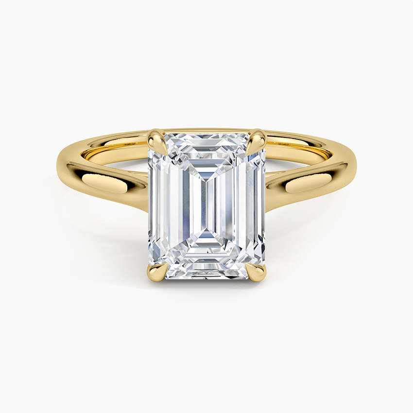 Emerald cut moissanite in a cathedral arch setting in yellow gold, top view