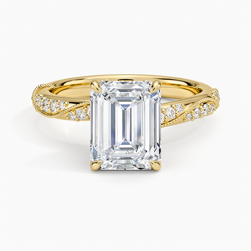 Emerald cut moissanite on a double twist band with milgrain pave in yellow gold, top view