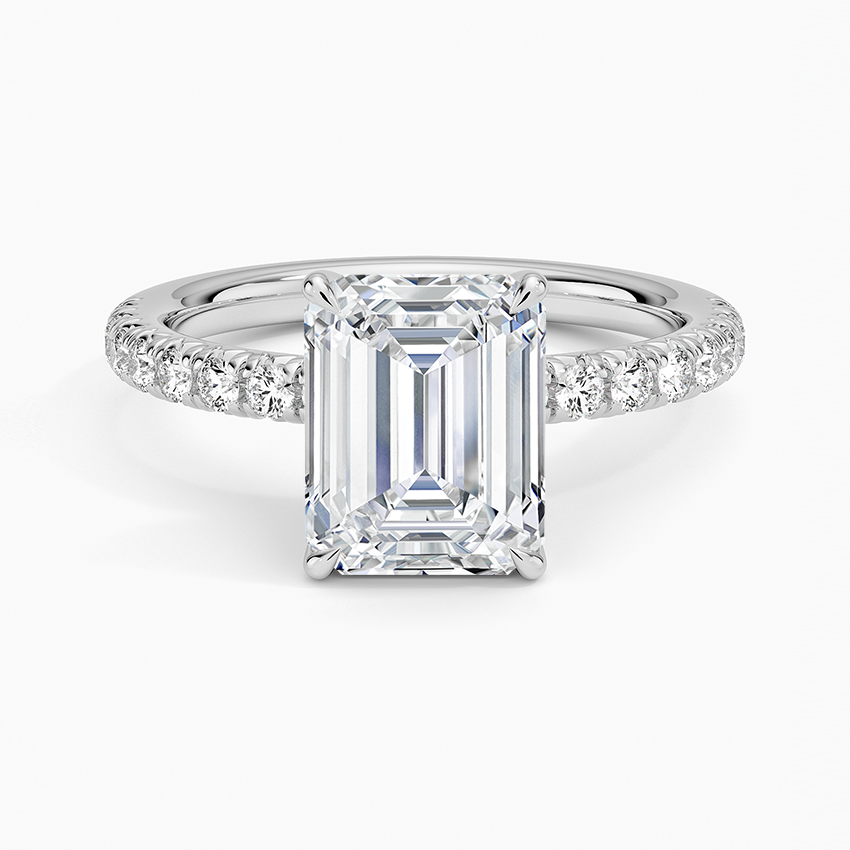 Emerald cut moissanite on a French pave band in white gold, top view