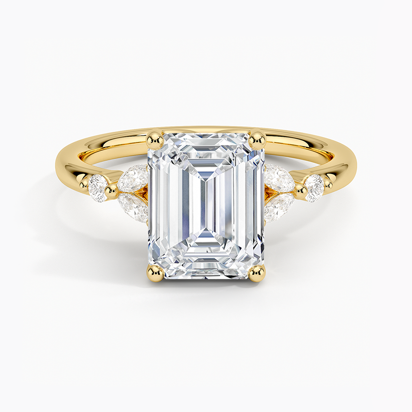 Emerald cut moissanite with marquise cluster accents in yellow gold, top view