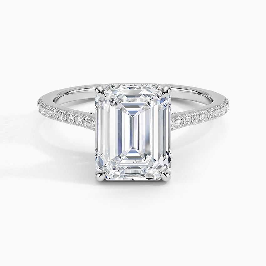 Emerald cut moissanite on a petite micropave band with hidden halo in white gold, top view