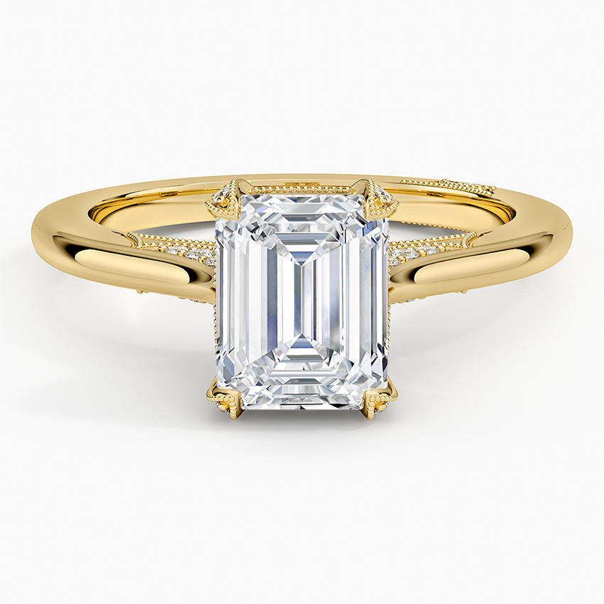 Emerald cut moissanite with a milgrain edged pave arch in yellow gold, top view