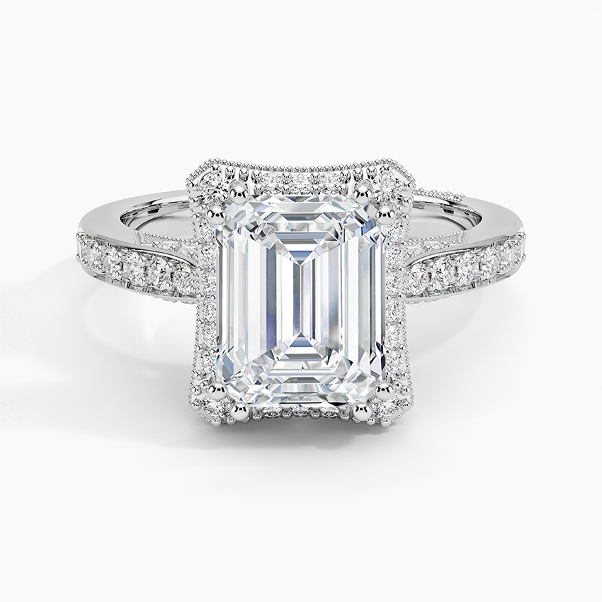 Emerald cut moissanite in a milgrain edged rectangular halo in white gold, top view