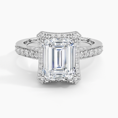 Emerald cut moissanite in a milgrain edged rectangular halo in white gold, top view