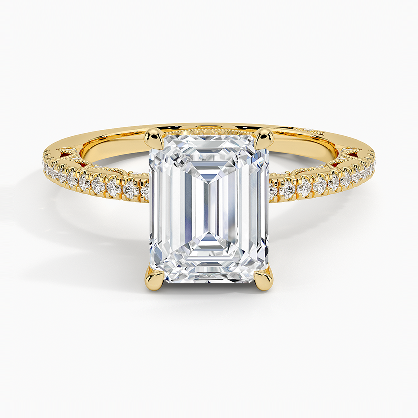Emerald cut moissanite with micropave along the crown of the band in yellow gold, top view
