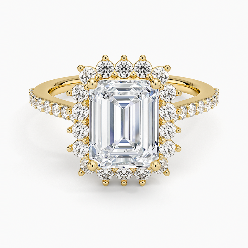 Emerald cut moissanite scalloped sunburst halo ring with pave shoulders in yellow gold, top view