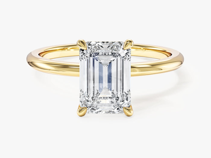 Emerald cut lab grown diamond minimalist engagement ring on a plain thin yellow gold band, front view