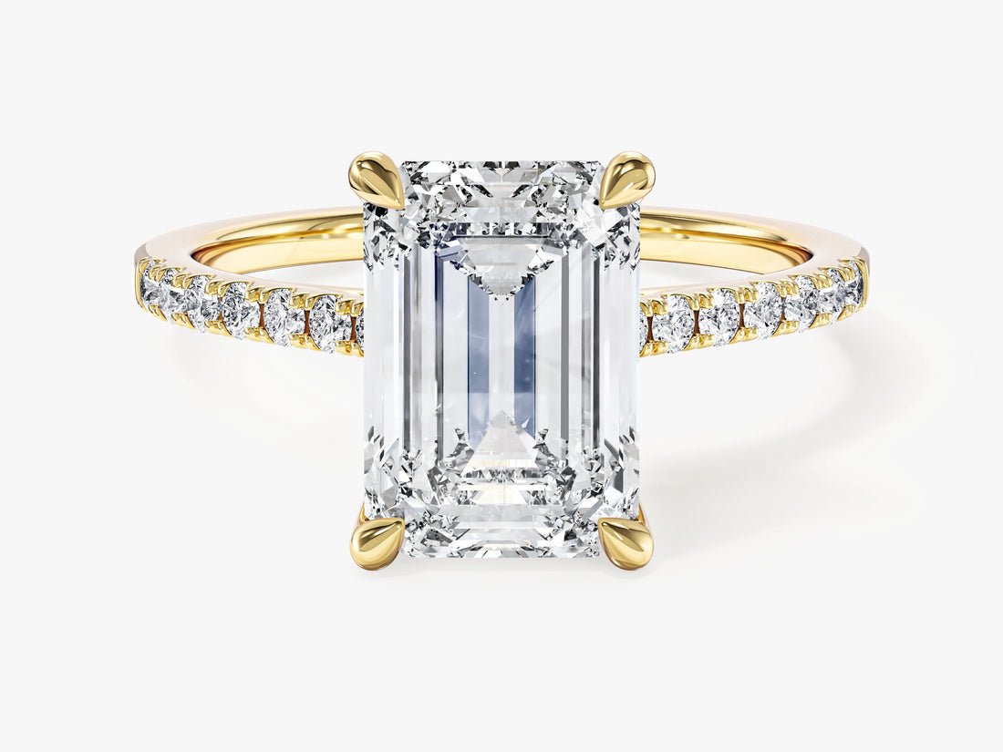 Emerald cut moissanite engagement ring with pave band in 14K yellow gold, front view