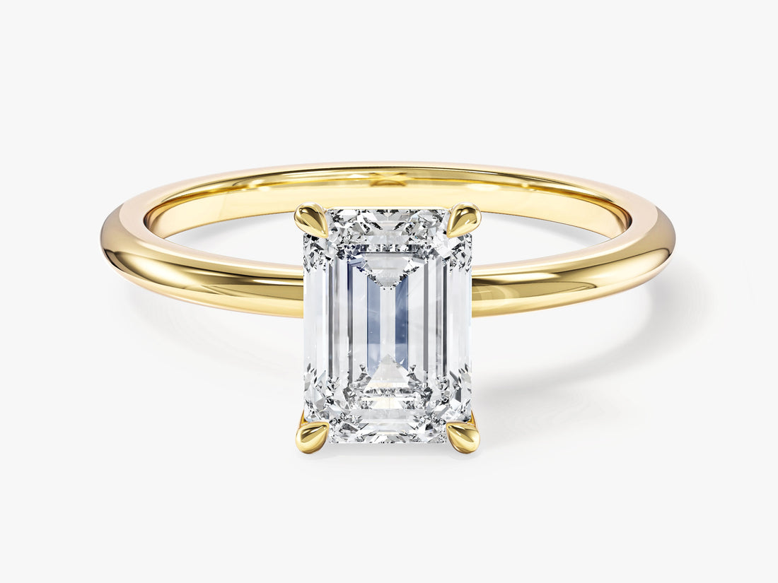 Minimalist emerald cut moissanite solitaire engagement ring in yellow gold, front view