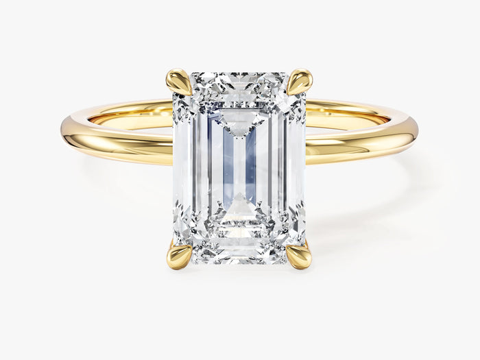 Emerald cut lab grown diamond statement solitaire with four prong basket in yellow gold, front view