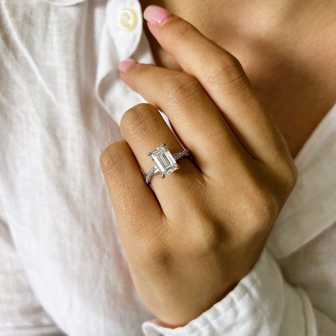 Emerald cut moissanite twisted pave engagement ring in white gold