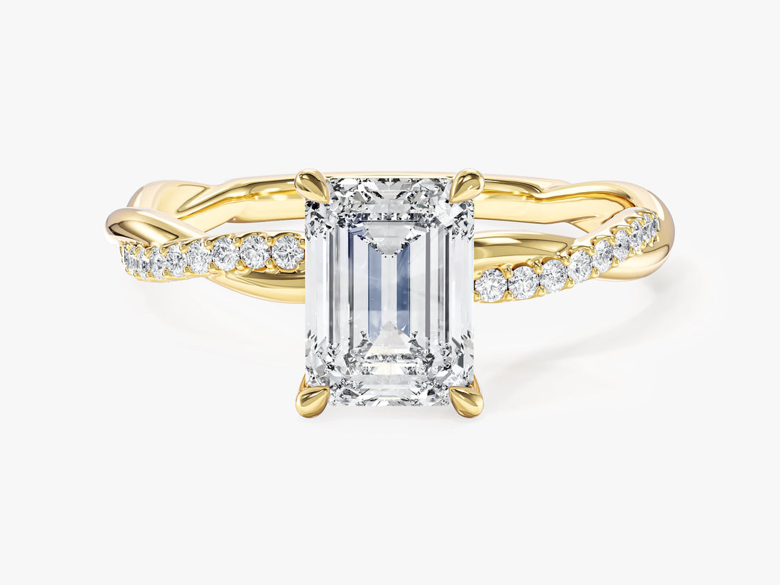 Emerald cut lab grown diamond twisted engagement ring with pave set side stones in yellow gold, front view