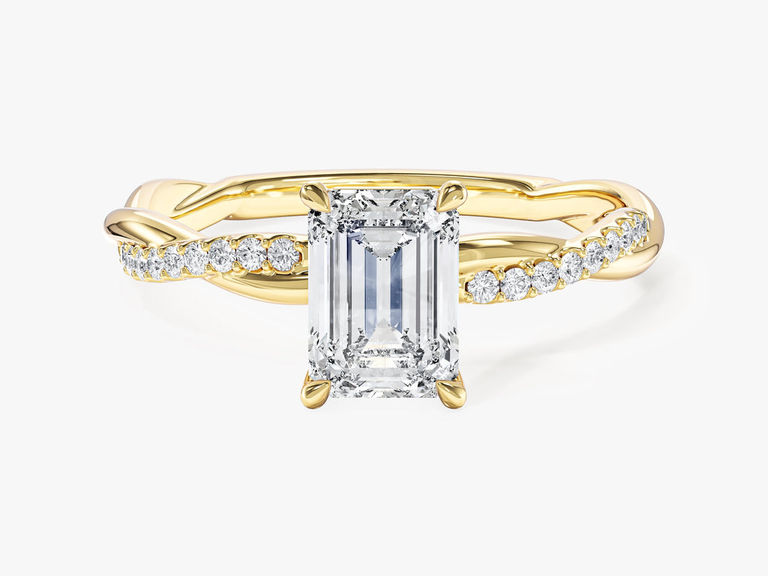 Emerald cut lab grown diamond infinity twist engagement ring in yellow gold with a half pave strand, front view
