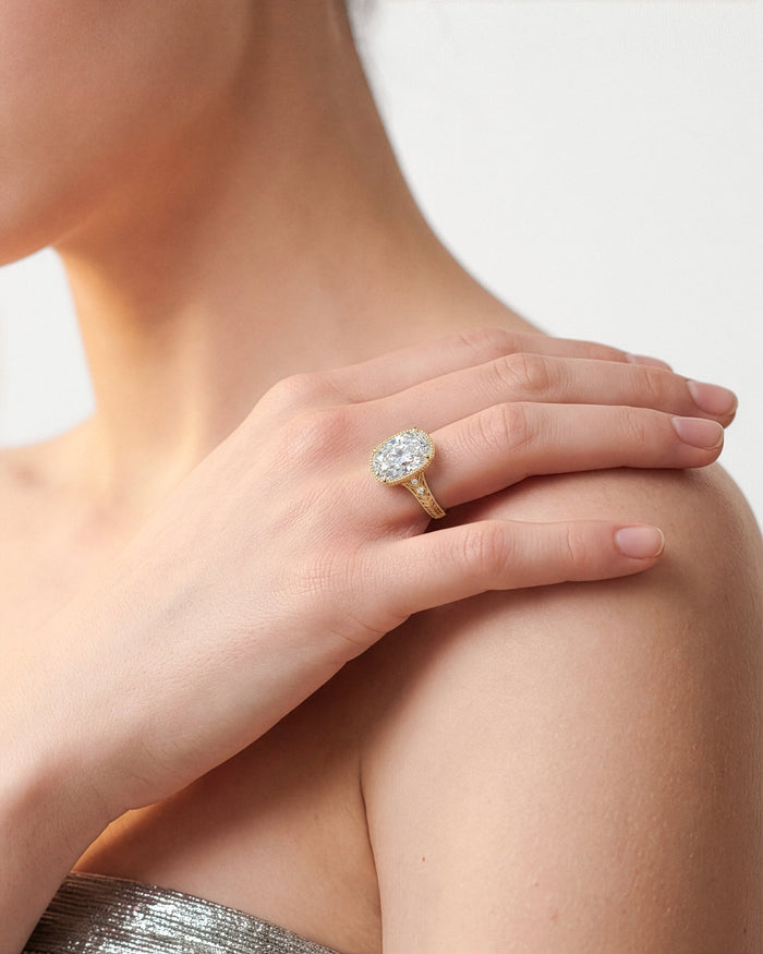 Elongated cushion lab grown diamond vintage milgrain ring worn on a hand resting on the shoulder
