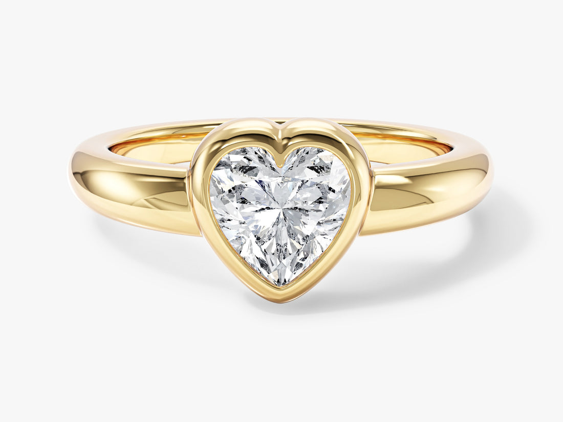 Heart shaped moissanite bezel solitaire engagement ring with rounded dome band in 14K yellow gold, front view