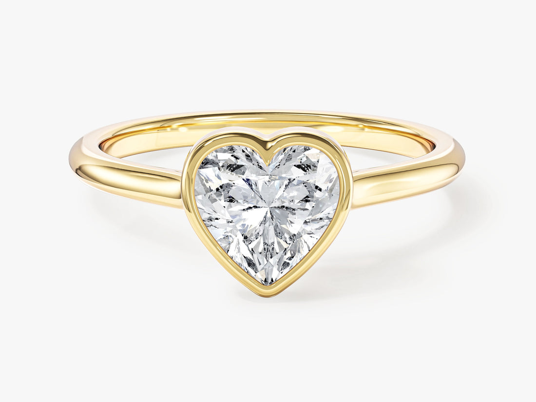 Heart lab grown diamond bezel solitaire engagement ring in yellow gold, front view